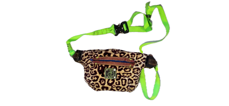 A leopard print dog harness bag with a bright neon green adjustable strap and collar, shown on a plain white background.