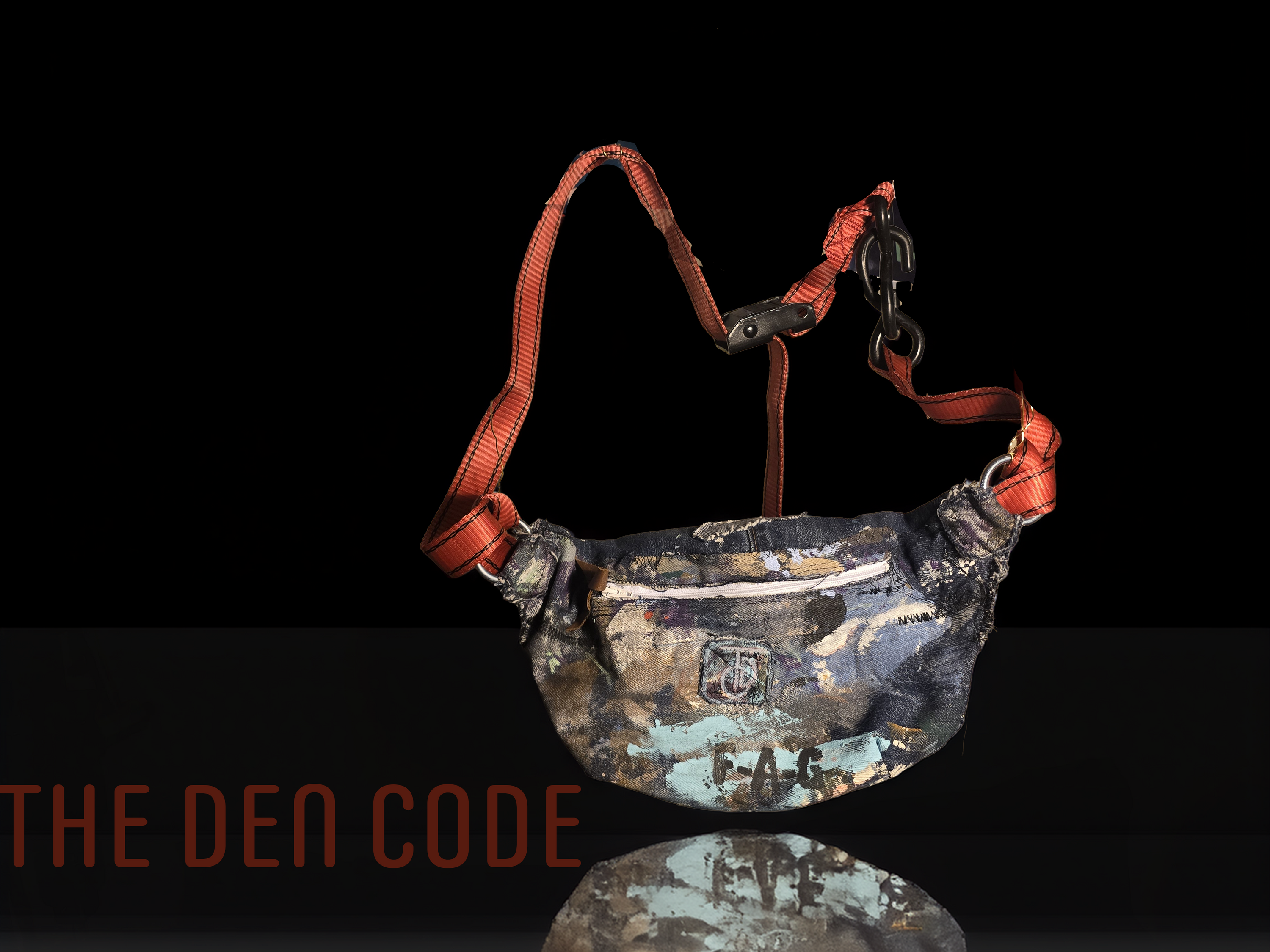 Camouflage bag with straps and 'DESSCHUL' text on a black background, featuring 'The Den Code' branding.